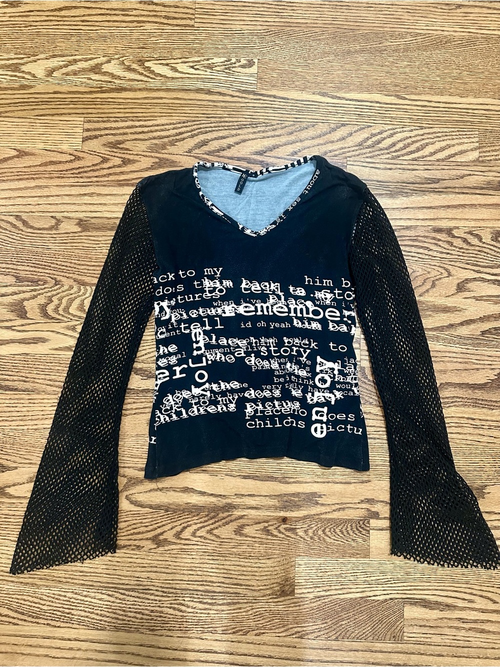 KC Gold Black Graphic Mesh Sleeve V-Neck Top